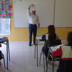 Educador presentado una hoja escrita a sus alumnos